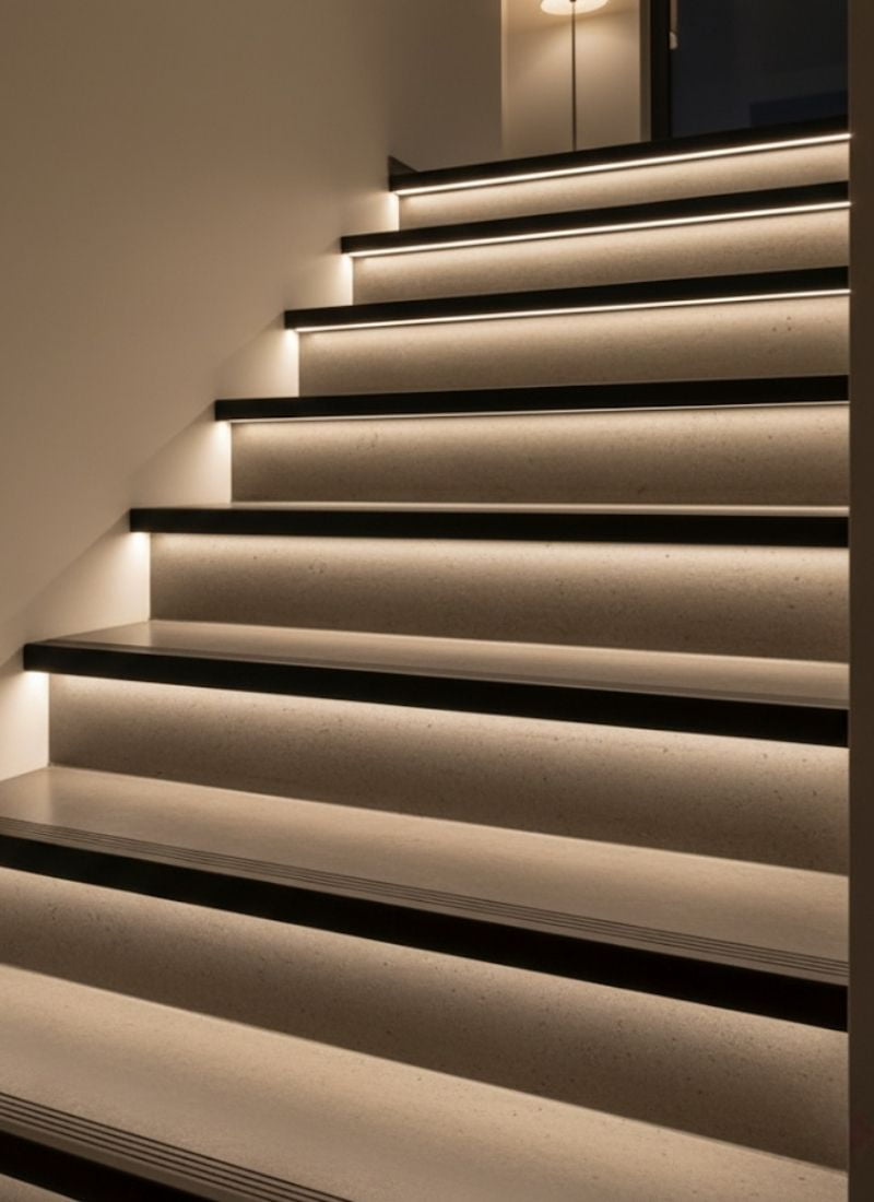 Close-up of an aluminum LED channel and snap-on diffuser in a stair-nosing profile