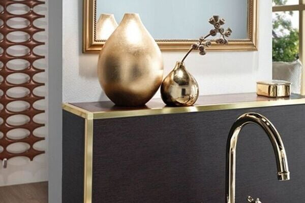Brass square edge tile trim finishing a tiled edge
