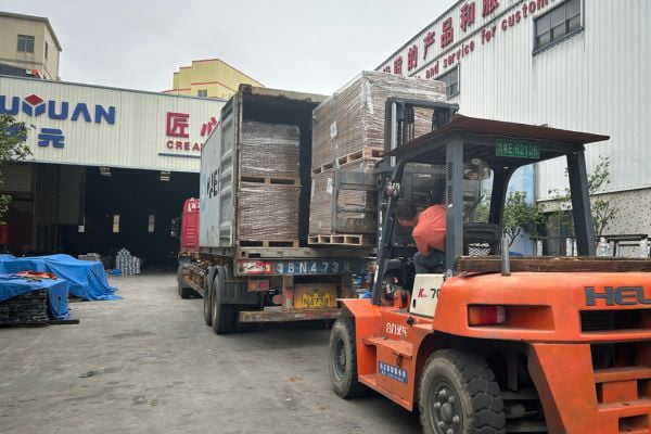 Tile trim cartons being loaded into a shipping container for export