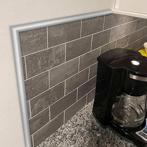 Light-colored trim finishing a kitchen tile wall end and top edge