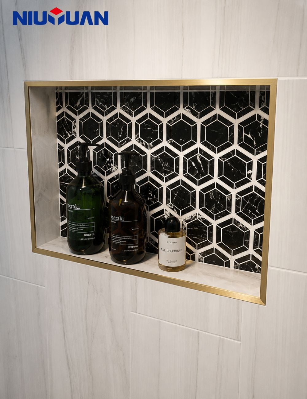 Gold-colored trim framing a recessed niche in a pale tiled wall