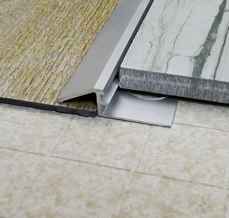 Floor transition profile detail between tile and an adjacent floor surface
