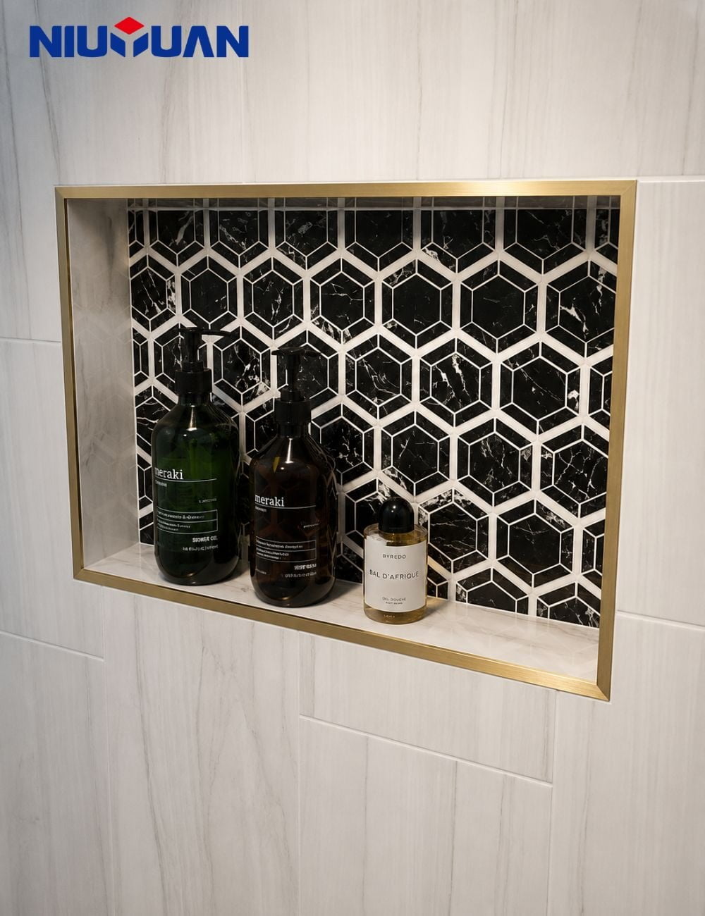 Gold tile trim edging a tiled shower niche