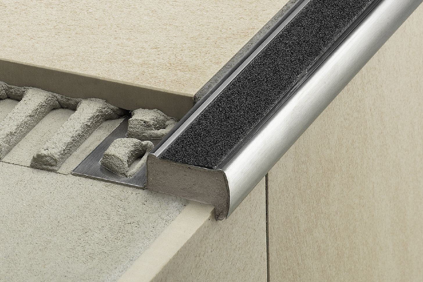 Shower wall tile edges finished with metal trim