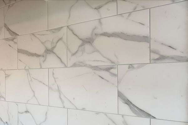 Marble-look rectangular wall tiles arranged in a staggered layout